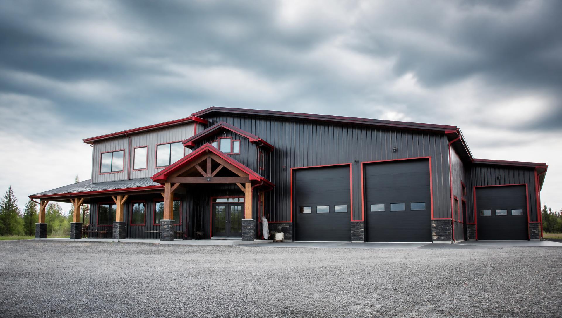 Large modern steel building with charcoal cladding and red trim, representative of steel buildings by Fortune Steel Buildings Inc. in Barrie, Ontario